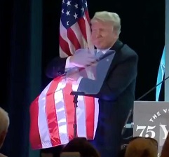 Trump hugs American flag